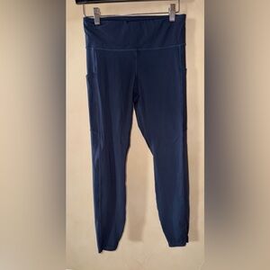 Vuori Stride Legging High Rise Side Pockets Zip Pocket Navy Blue 7/8 Length SZ S